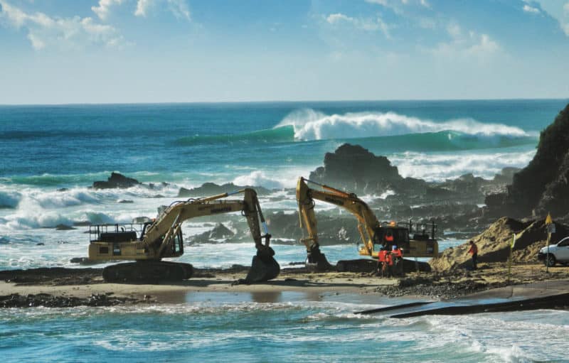 Excavators begin work on the Shire of East Gippsland's state-government-approved project to bury Bastion Point under tonnes of rock rubble and asphalt. Photo: Save Bastion Point